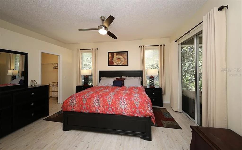5324 Cottonwood Tree Circle Valrico, FL 33596 - Photo 10 of 27 a bed room with a bed and a night stand