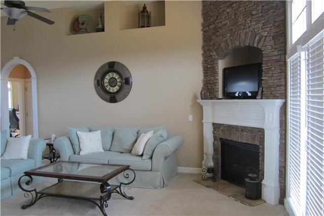 1082 Nealcrest Circle Spring Hill, TN 37174 - Photo 5 of 8 Living Room has vaulted ceilings and a corner stacked stone fireplace.