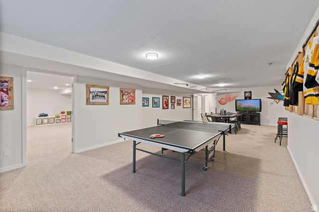 6208 West Bull River Road Highland, UT 84003 - Photo 50 of 90 Spacious carpeted recreation room featuring recessed lighting, a built-in wall display, and white trim