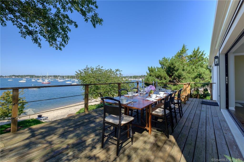 10 Morgan Point Groton, CT 06340 - Photo 13 of 40 a view of a roof deck with table and chairs a barbeque with wooden floor and fence