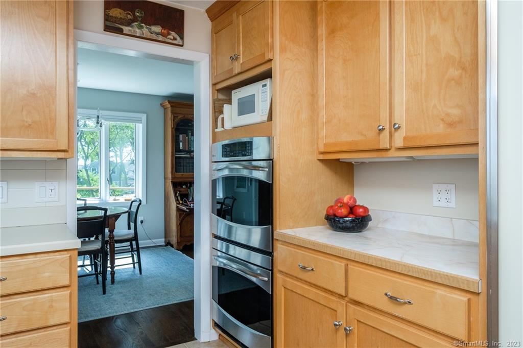 10 Morgan Point Groton, CT 06340 - Photo 15 of 40 a kitchen with stainless steel appliances granite countertop a stove a cabinets and chairs