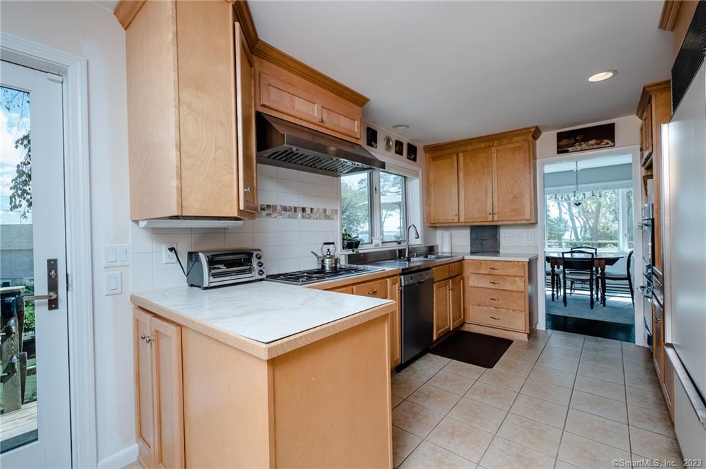 10 Morgan Point Groton, CT 06340 - Photo 16 of 40 a kitchen with stainless steel appliances granite countertop a sink stove and refrigerator