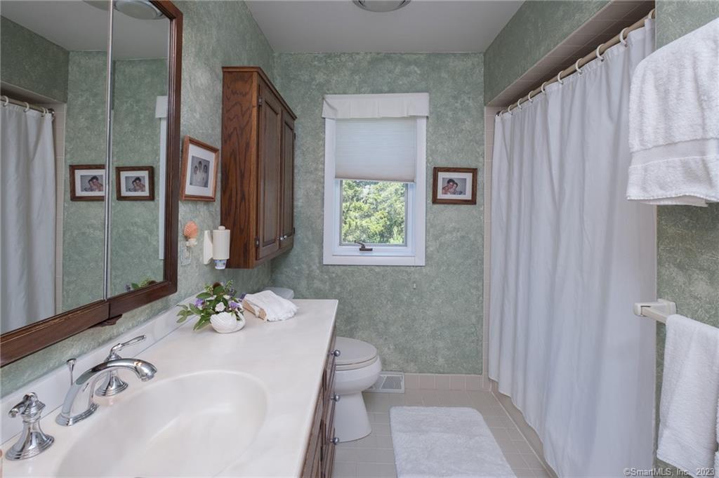 10 Morgan Point Groton, CT 06340 - Photo 20 of 40 a bathroom with a sink a toilet and shower curtain