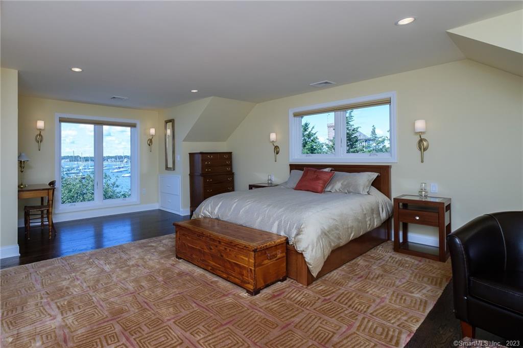 10 Morgan Point Groton, CT 06340 - Photo 23 of 40 a bedroom with a large bed a flat tv screen and a window