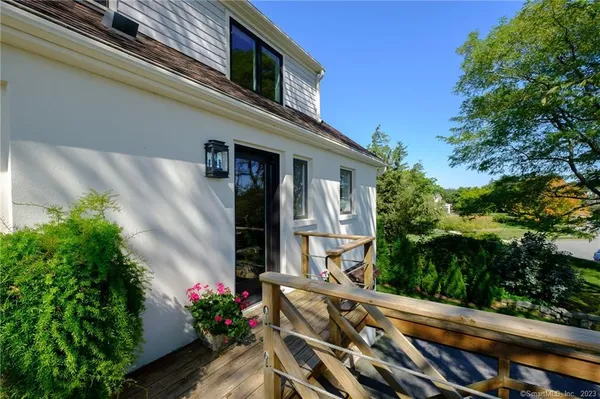 a view of a house with a yard and potted plants