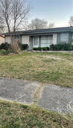 a front view of house with yard and trees