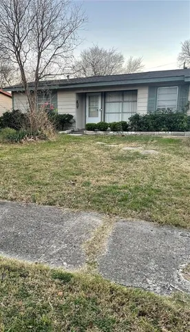 a front view of house with yard and trees
