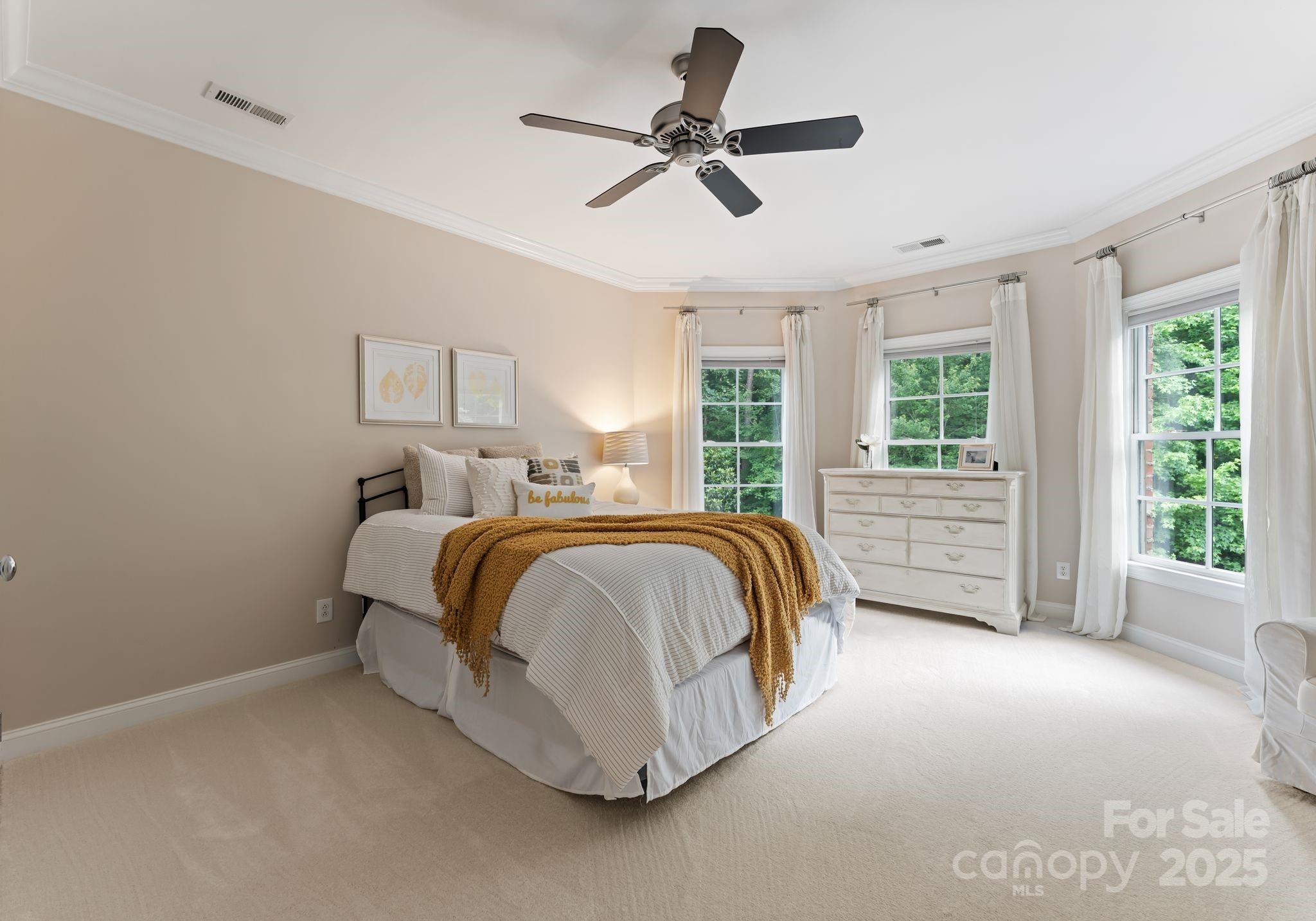 408 Covington Crossing Matthews, NC 28104 - Photo 36 of 46 a spacious bedroom with a bed and ceiling fan
