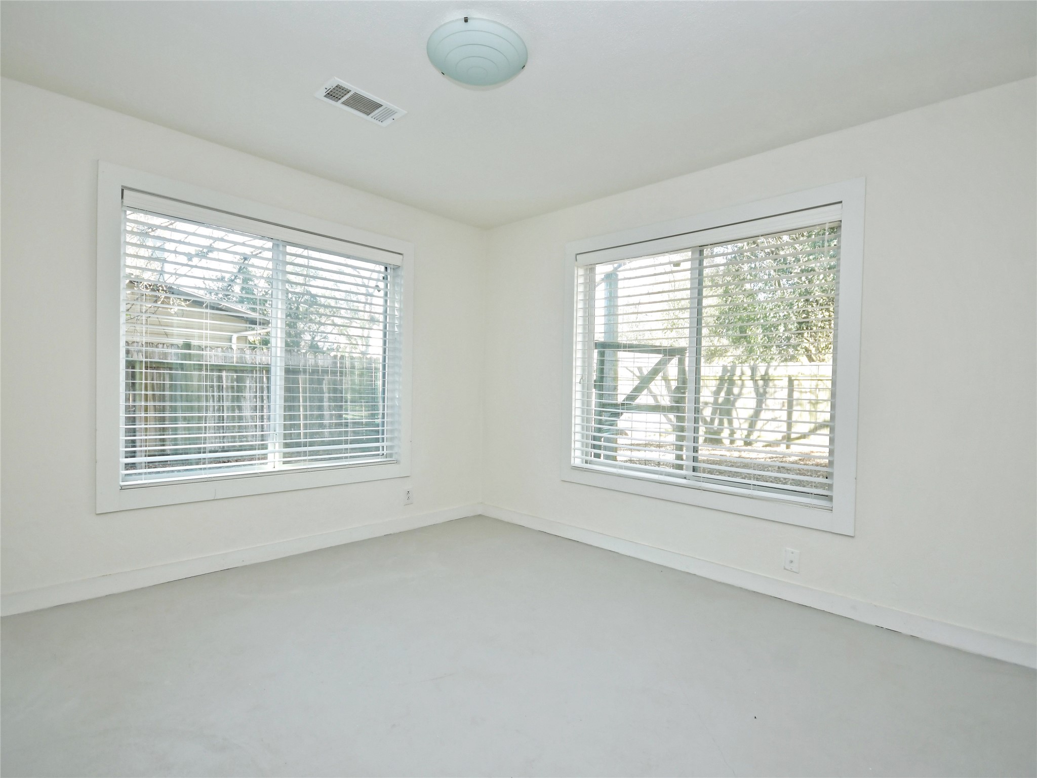 4604 Red River Street, Unit B Austin, TX 78751 - Photo 11 of 15 Two well-lit windows with blinds create a bright and airy atmosphere in this versatile room.