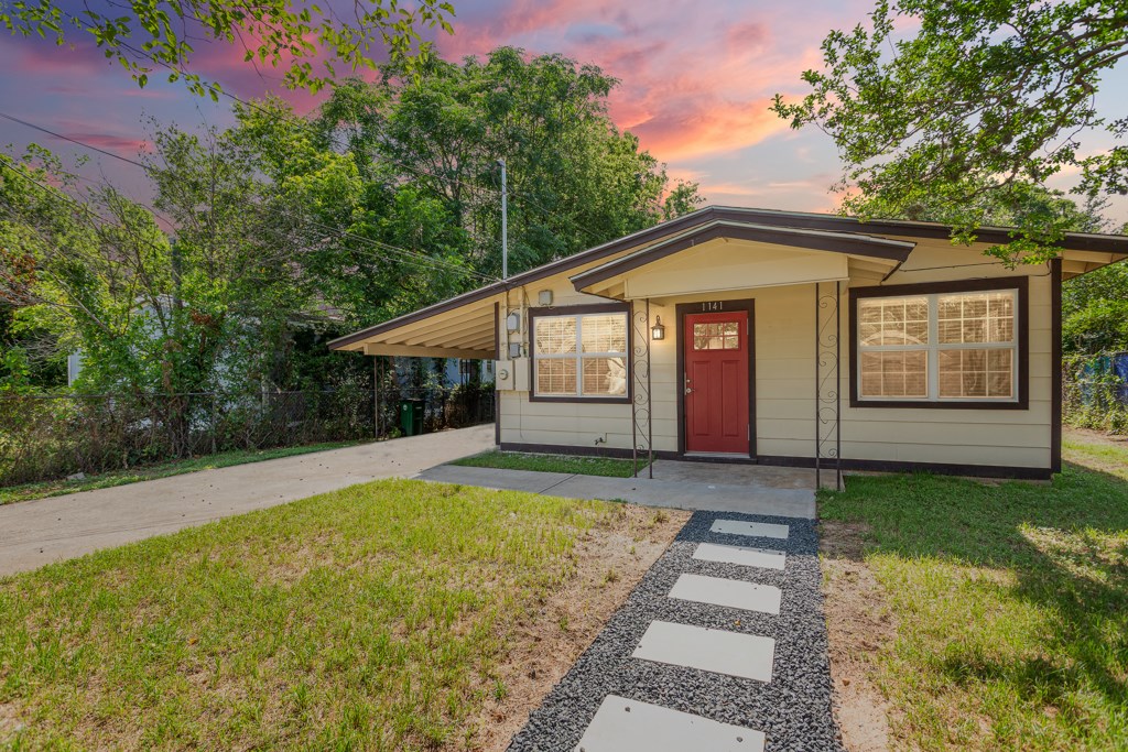 1141 Nickols Avenue Austin, TX 78721 - Photo 1 of 1 a front view of a house with garden