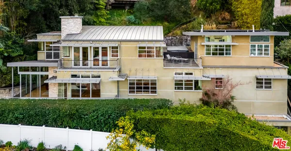 a front view of a residential apartment building with a yard