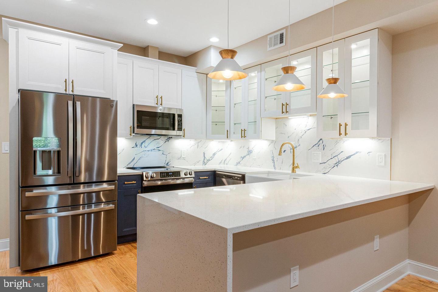 1609 17th Street Southeast, Unit 202 Washington, DC 20020 - Photo 1 of 19 a kitchen with kitchen island a counter top space a sink stainless steel appliances and cabinets