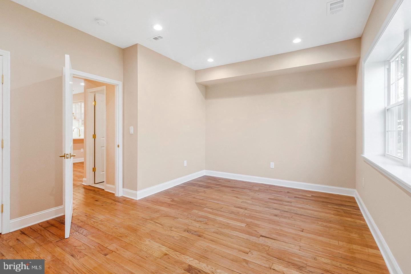 1609 17th Street Southeast, Unit 202 Washington, DC 20020 - Photo 13 of 19 an empty room with wooden floor and windows