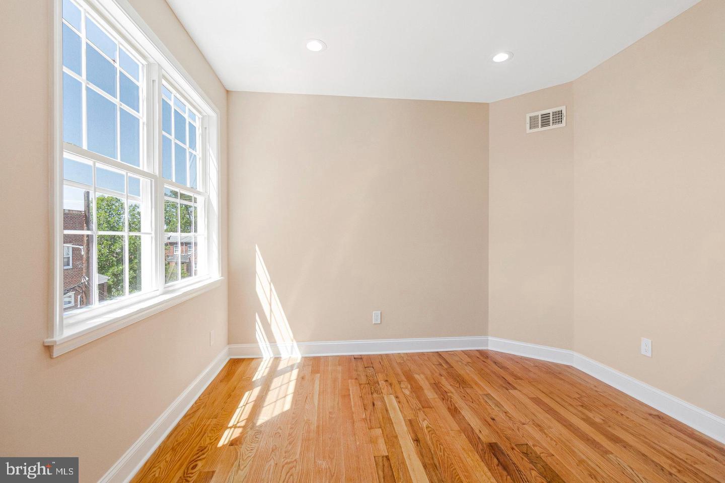 1609 17th Street Southeast, Unit 202 Washington, DC 20020 - Photo 15 of 19 a view of an empty room with wooden floor and a window