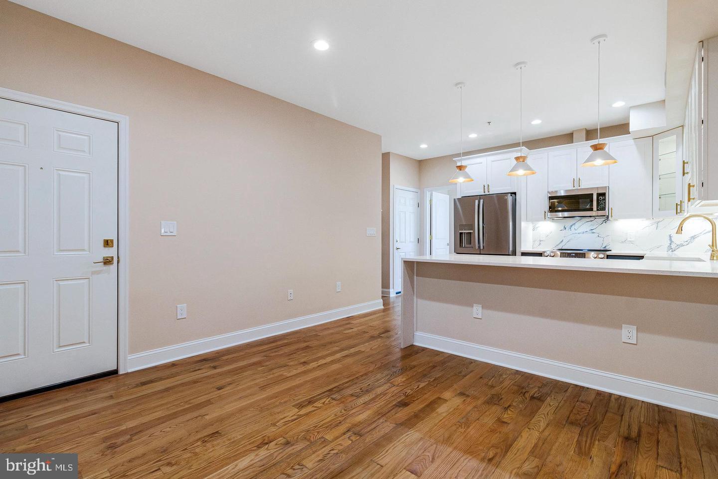 1609 17th Street Southeast, Unit 202 Washington, DC 20020 - Photo 4 of 19 a view of kitchen with wooden floor and electronic appliances