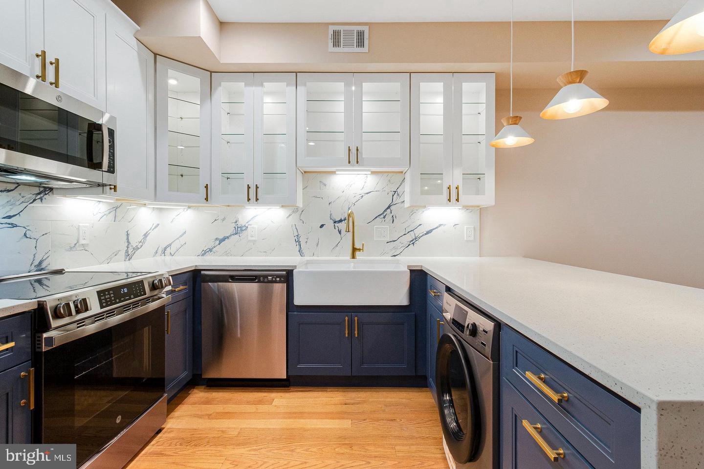 1609 17th Street Southeast, Unit 202 Washington, DC 20020 - Photo 6 of 19 a kitchen with stainless steel appliances a sink stove and microwave