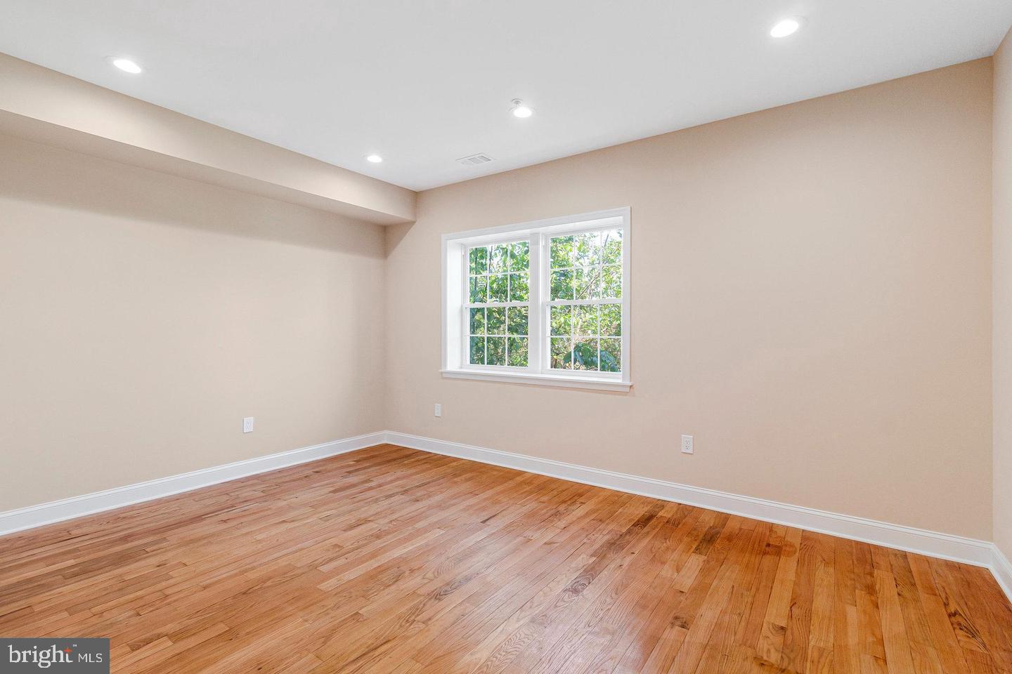 1609 17th Street Southeast, Unit 202 Washington, DC 20020 - Photo 9 of 19 an empty room with wooden floor and windows