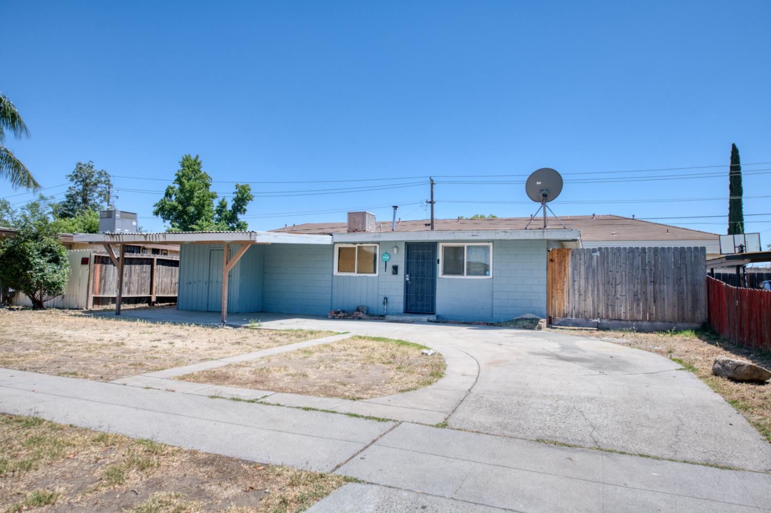 2326 East Hampton Way Fresno, CA 93726 - Photo 1 of 22 a front view of a house with a yard and garage