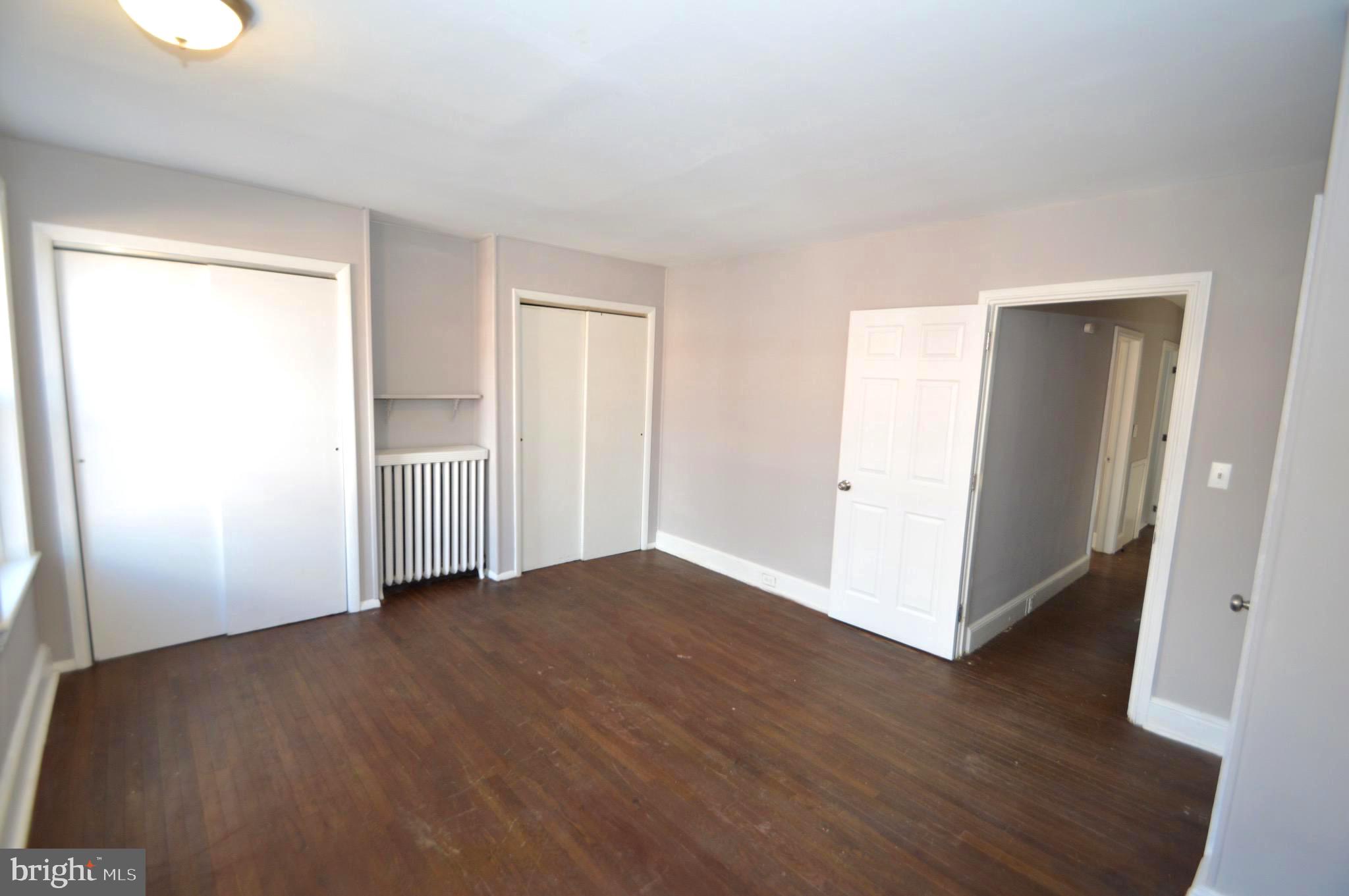 348 Barclay Street Burlington, NJ 08016 - Photo 11 of 21 an empty room with wooden floor and windows