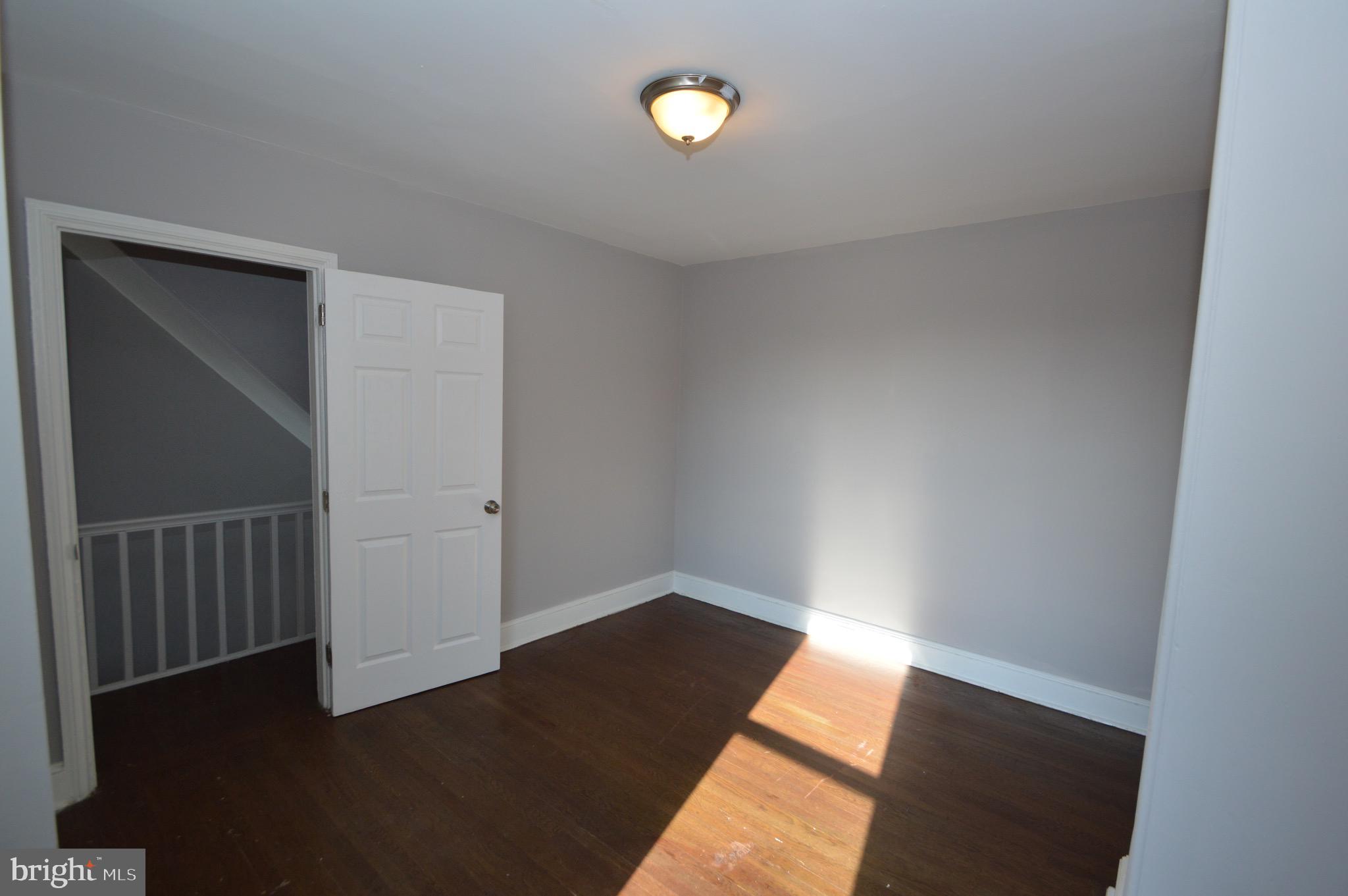 348 Barclay Street Burlington, NJ 08016 - Photo 12 of 21 an empty room with wooden floor and windows