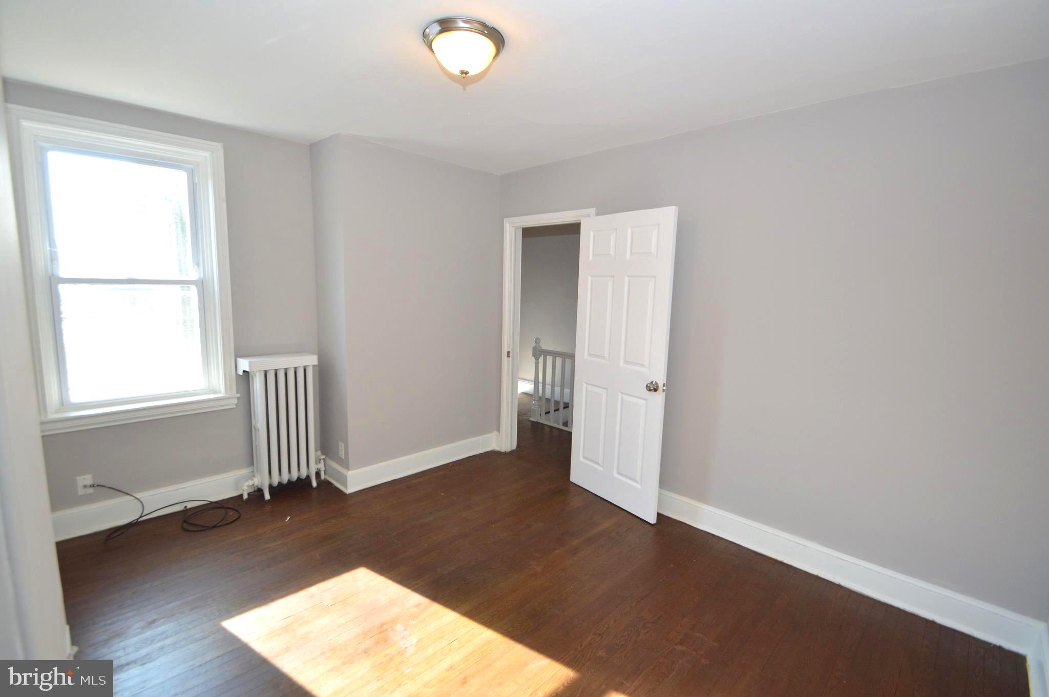 348 Barclay Street Burlington, NJ 08016 - Photo 13 of 21 an empty room with wooden floor and windows