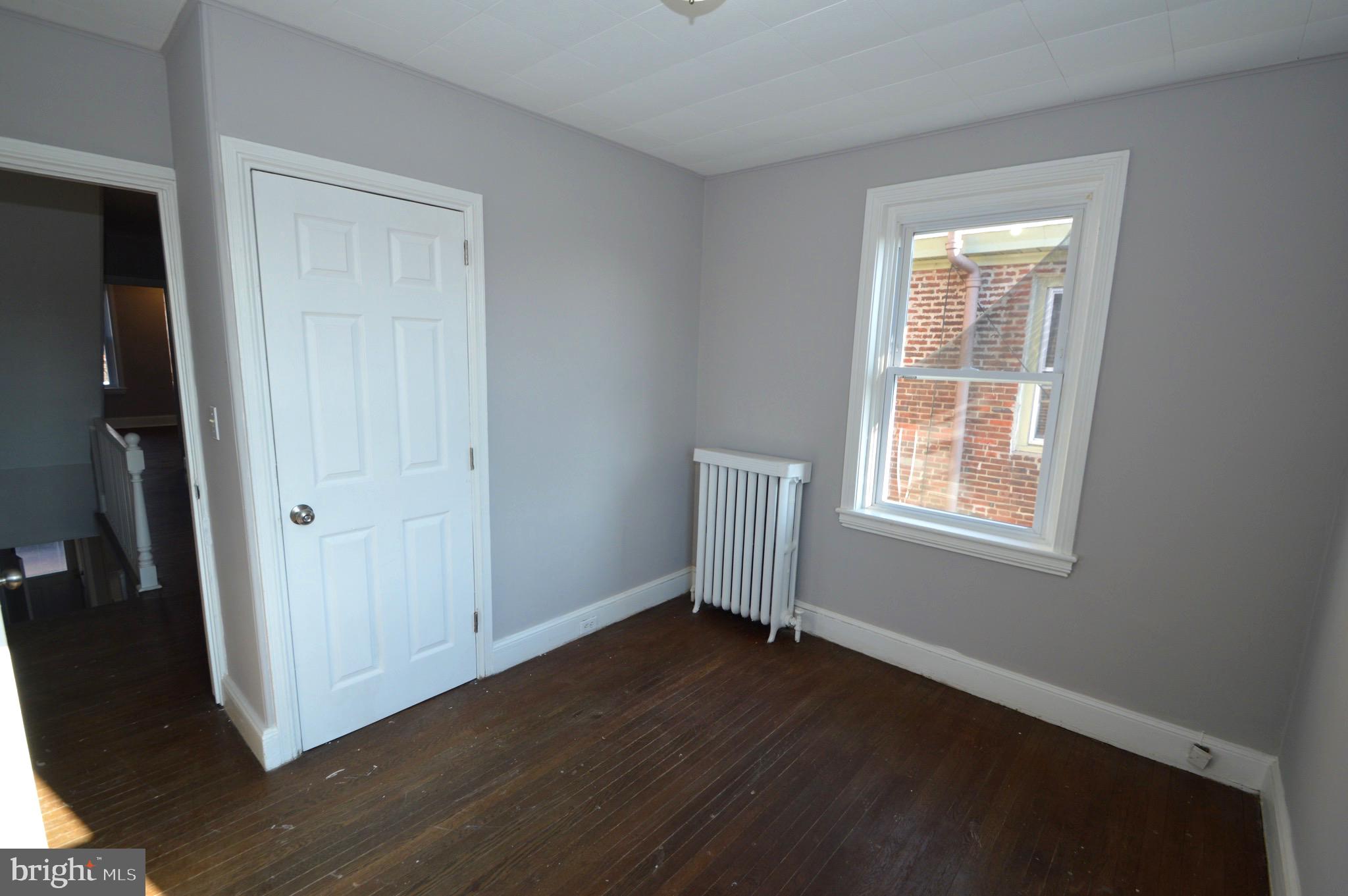 348 Barclay Street Burlington, NJ 08016 - Photo 14 of 21 an empty room with wooden floor and windows