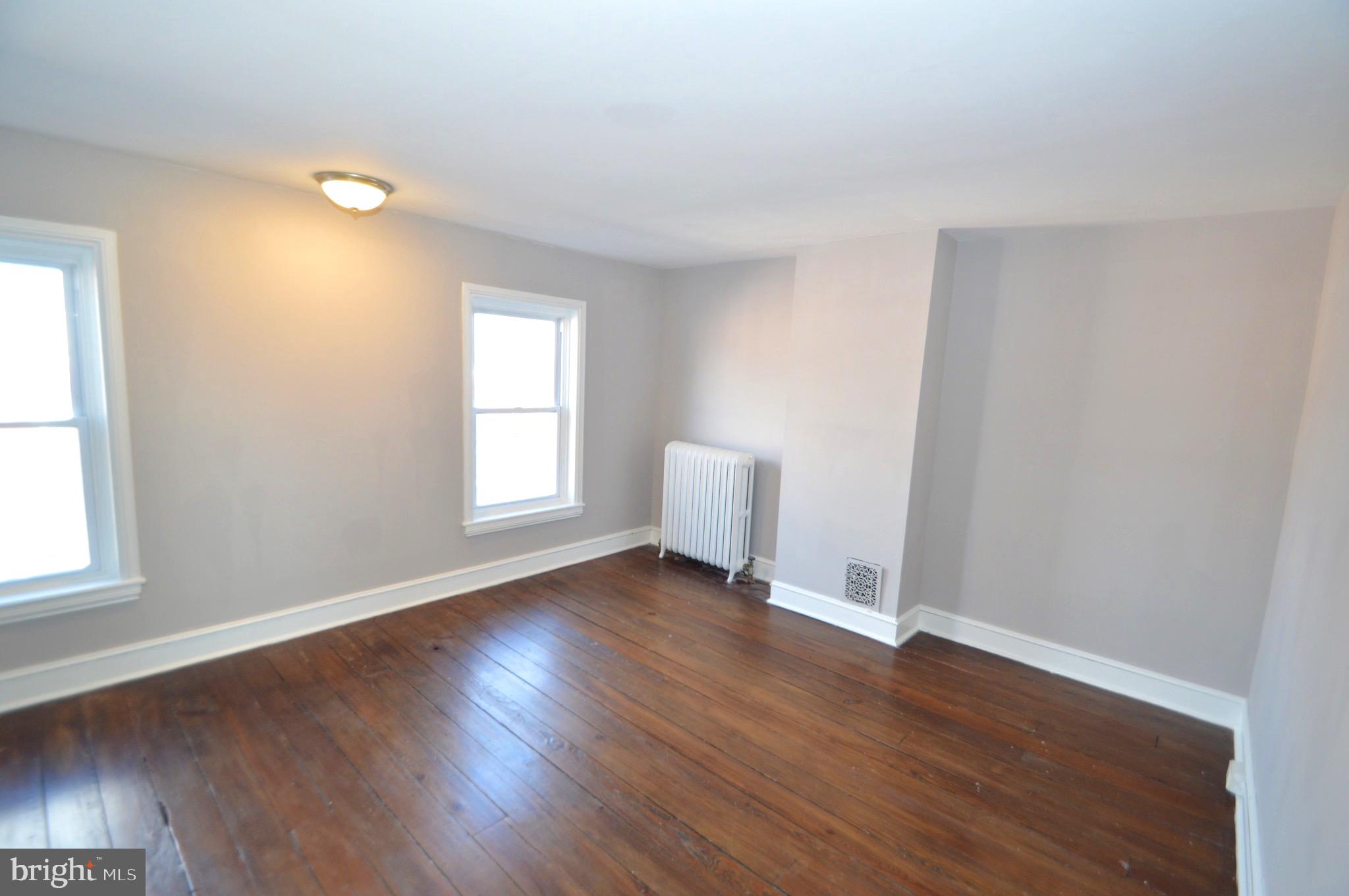 348 Barclay Street Burlington, NJ 08016 - Photo 16 of 21 an empty room with wooden floor and windows