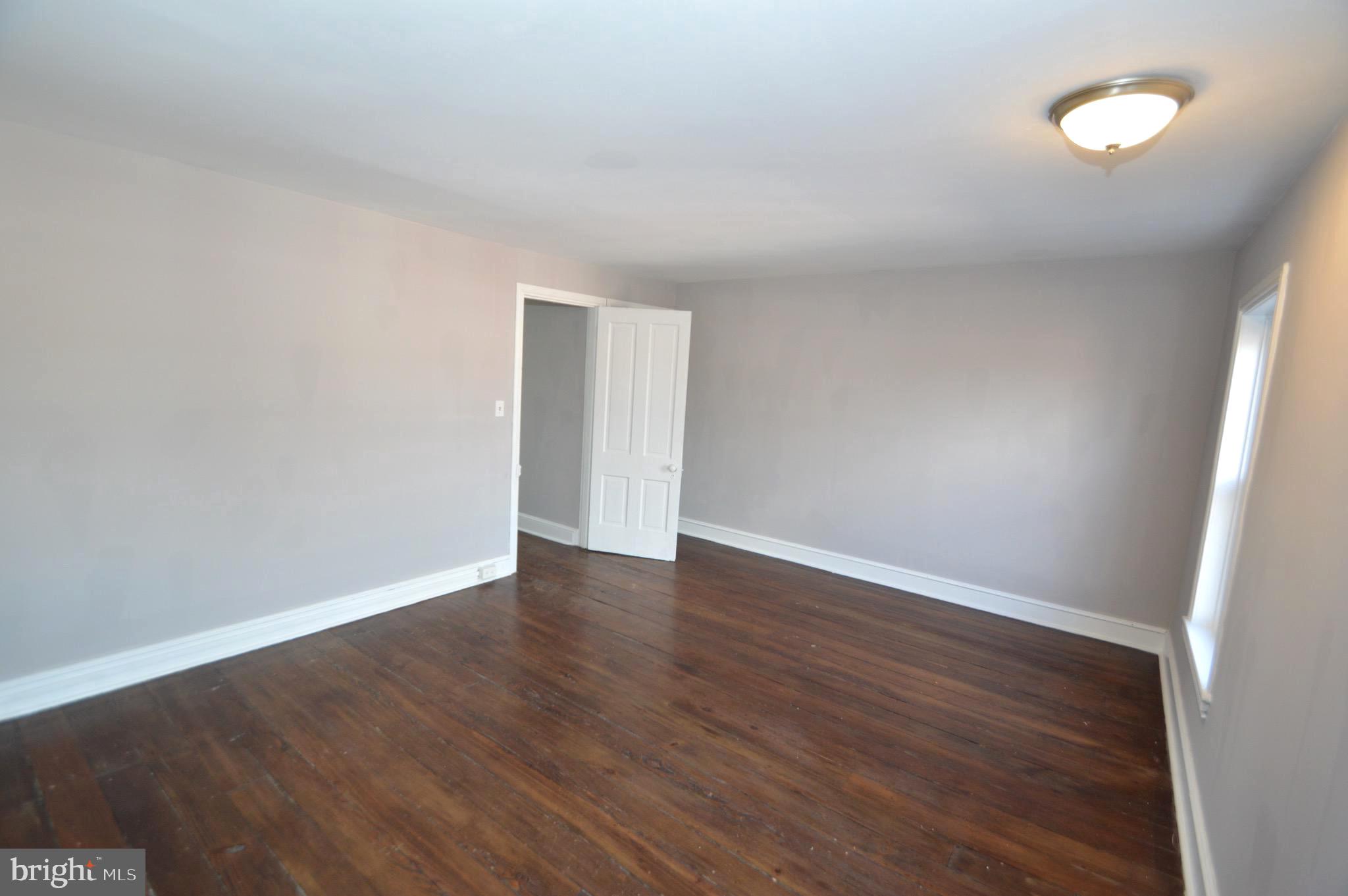 348 Barclay Street Burlington, NJ 08016 - Photo 17 of 21 a view of an empty room with wooden floor and a window