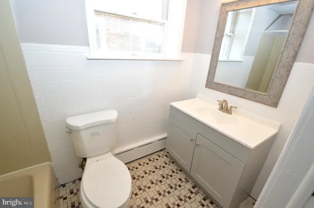 a white toilet sitting next to a bathroom sink