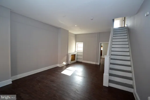 a view of wooden floor and windows in a room