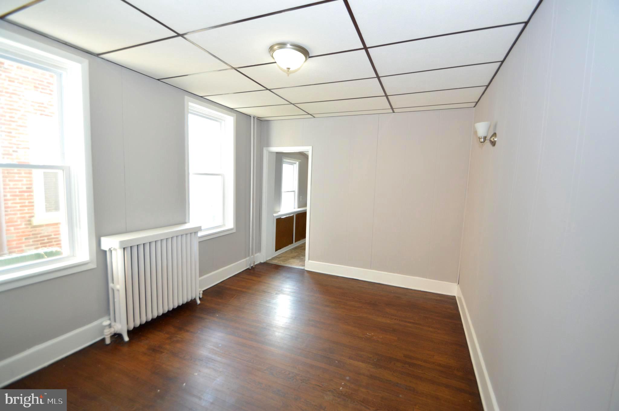 348 Barclay Street Burlington, NJ 08016 - Photo 5 of 21 an empty room with wooden floor and windows