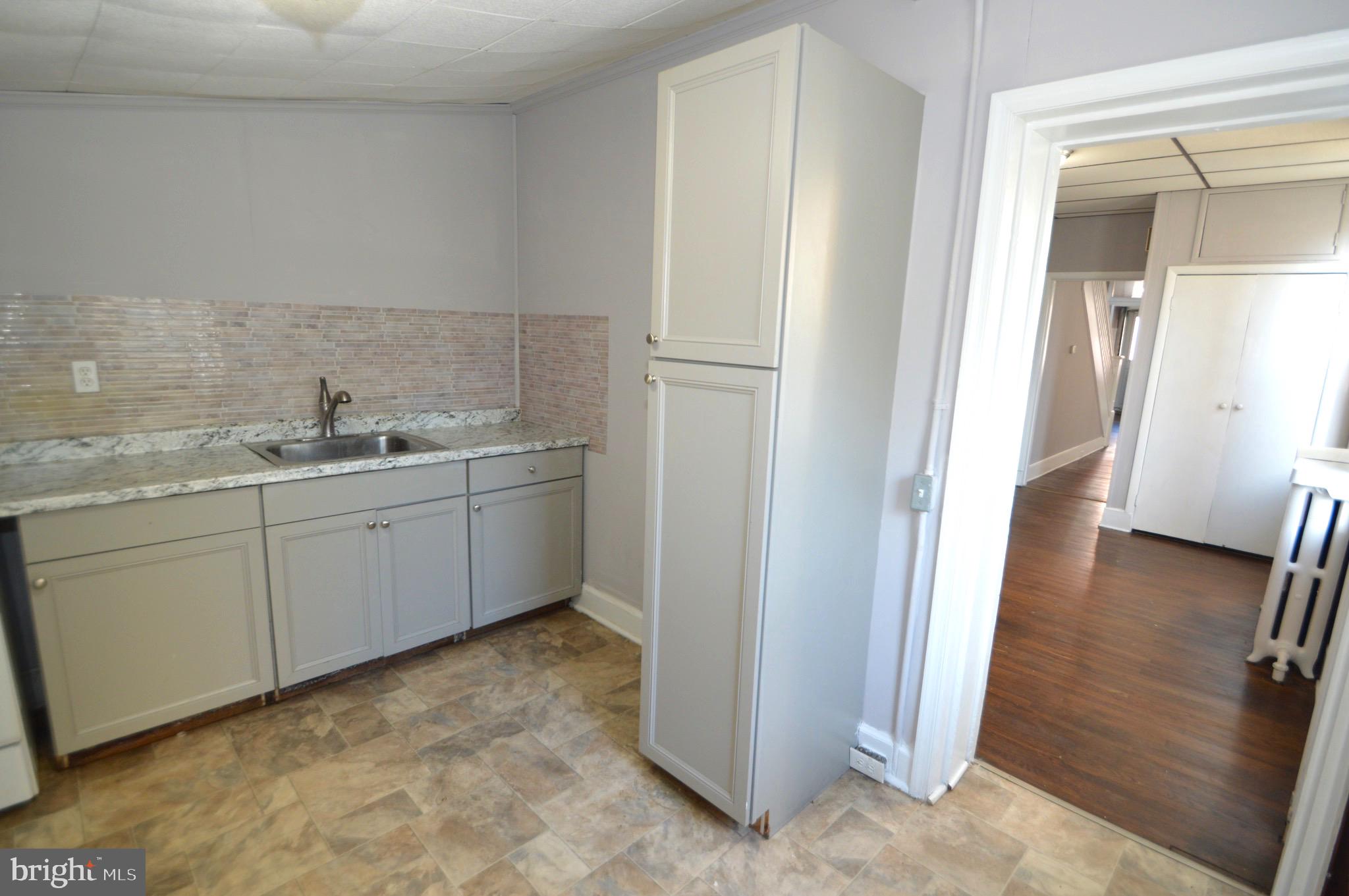 348 Barclay Street Burlington, NJ 08016 - Photo 8 of 21 a kitchen with a sink and refrigerator