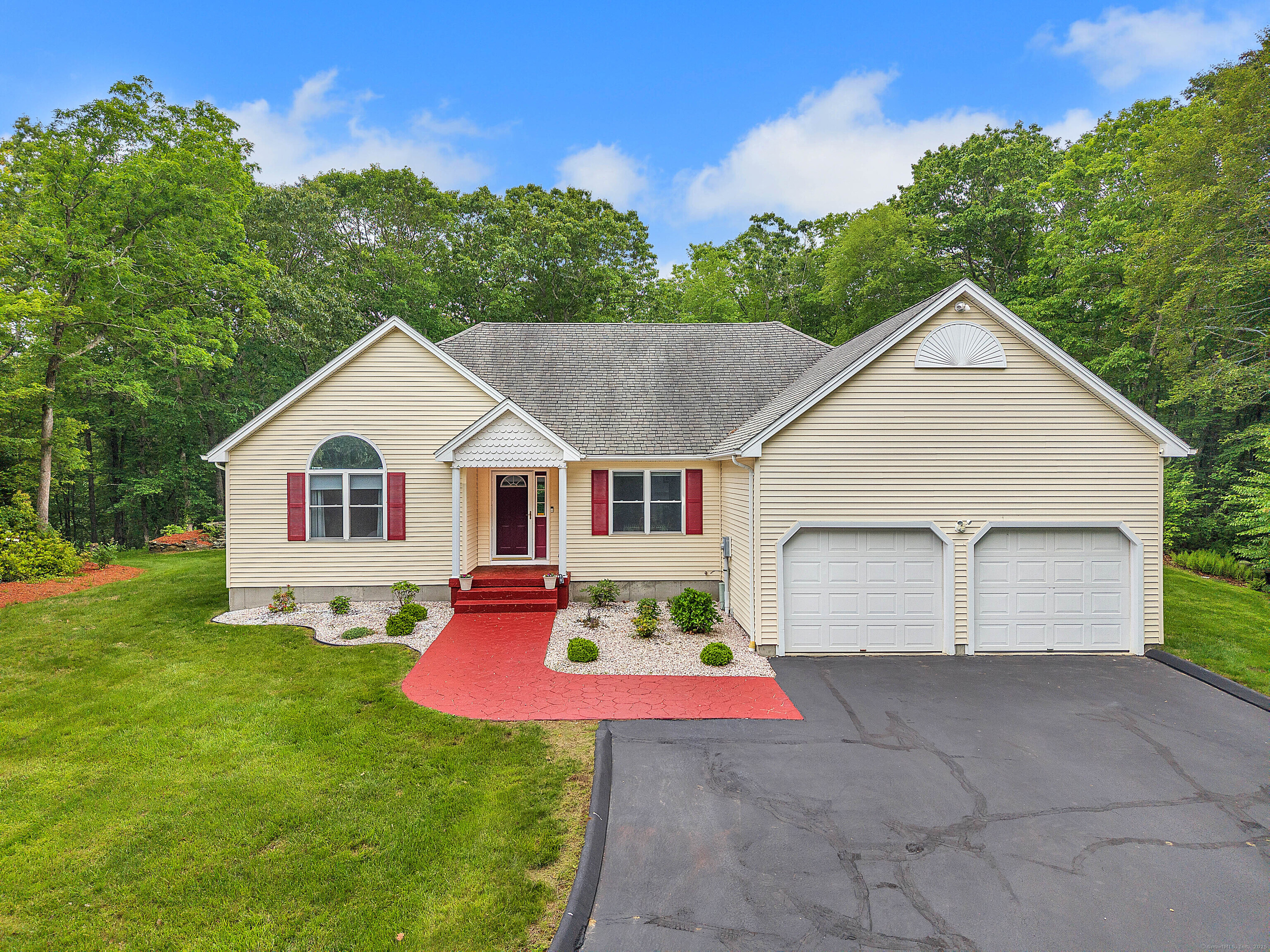 a front view of house with yard and green space