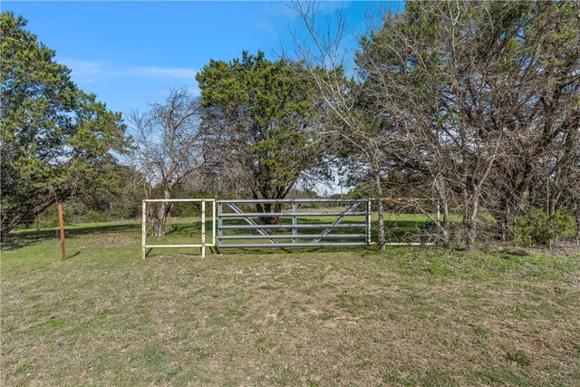 a backyard of a house with barbeque oven