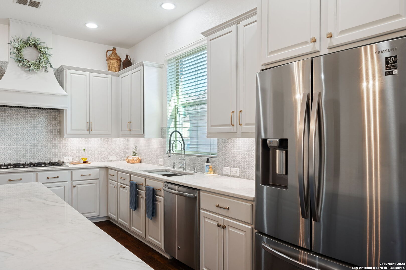 28827 Pfeiffers Gate Fair Oaks Ranch, TX 78015 - Photo 17 of 36 a kitchen with stainless steel appliances a refrigerator sink and cabinets