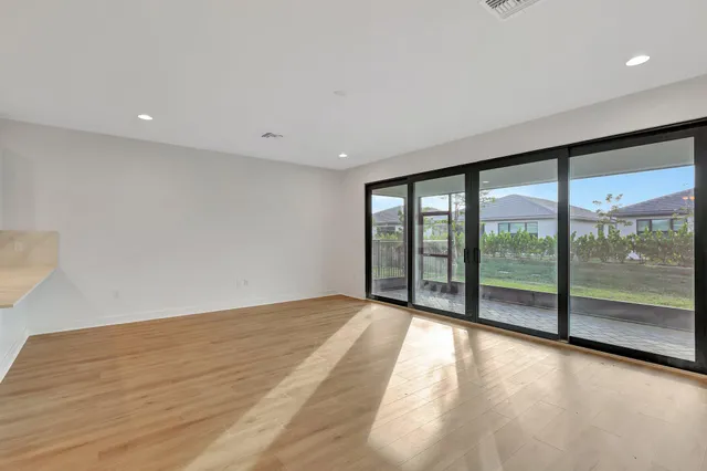 a view of a room with wooden floor