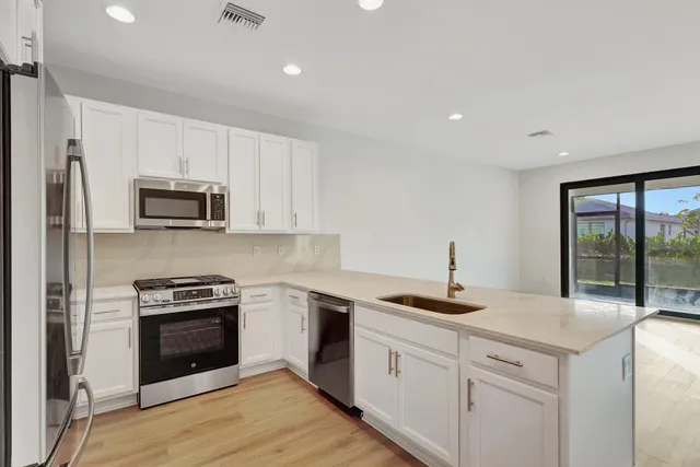 a kitchen with a refrigerator and a sink