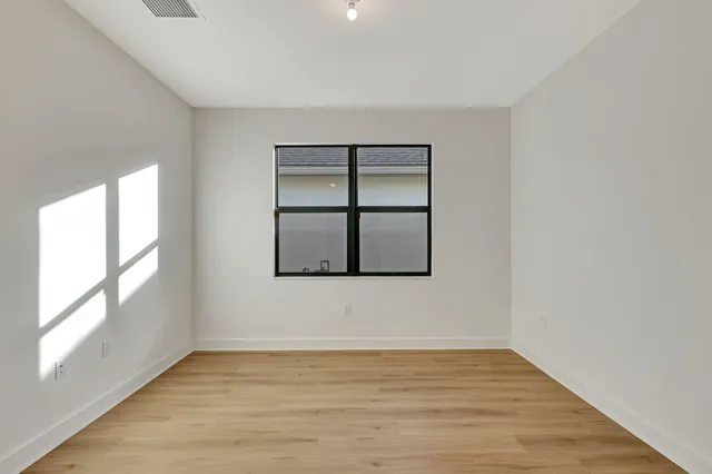 a large white kitchen with a sink and dishwasher with a large kitchen island