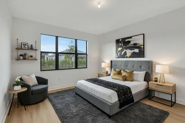 a open kitchen with white cabinets and wooden floor