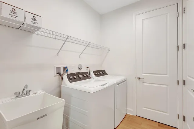 a street sign on a wall next to a road