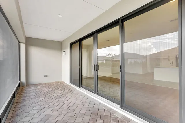 an aerial view of a house with swimming pool patio and lake view