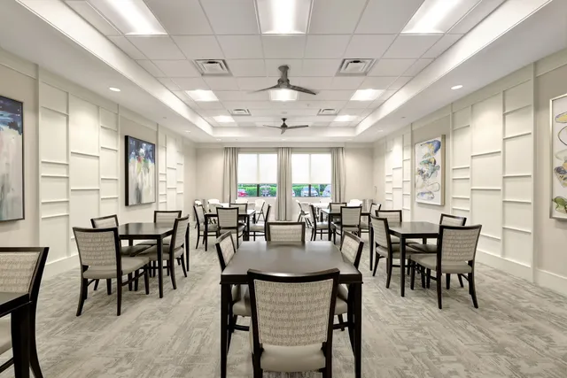 a living room with stainless steel appliances kitchen island granite countertop a large window