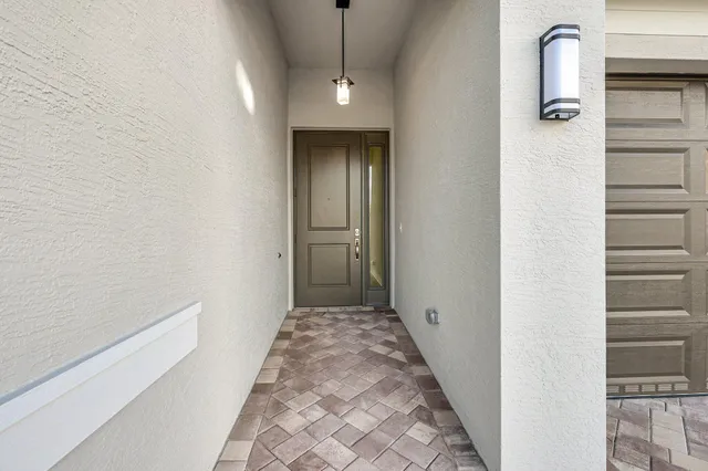 a kitchen with cabinets stainless steel appliances and wooden floor