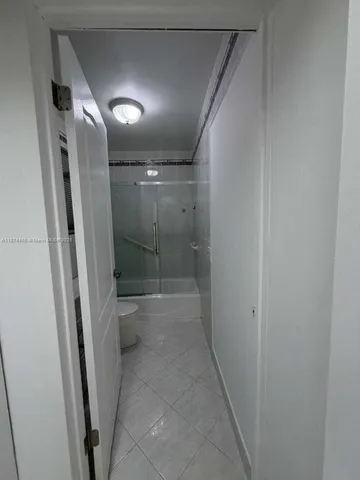 a bathroom with a shower and a toilet