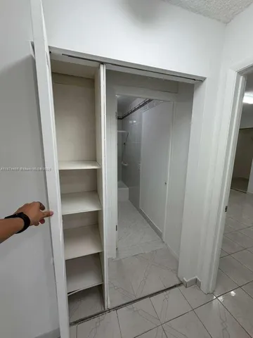 a view of walk in closet with empty racks