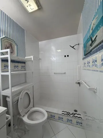 a bathroom with a sink a toilet and a shower