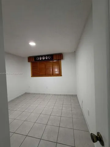 an empty room with kitchen