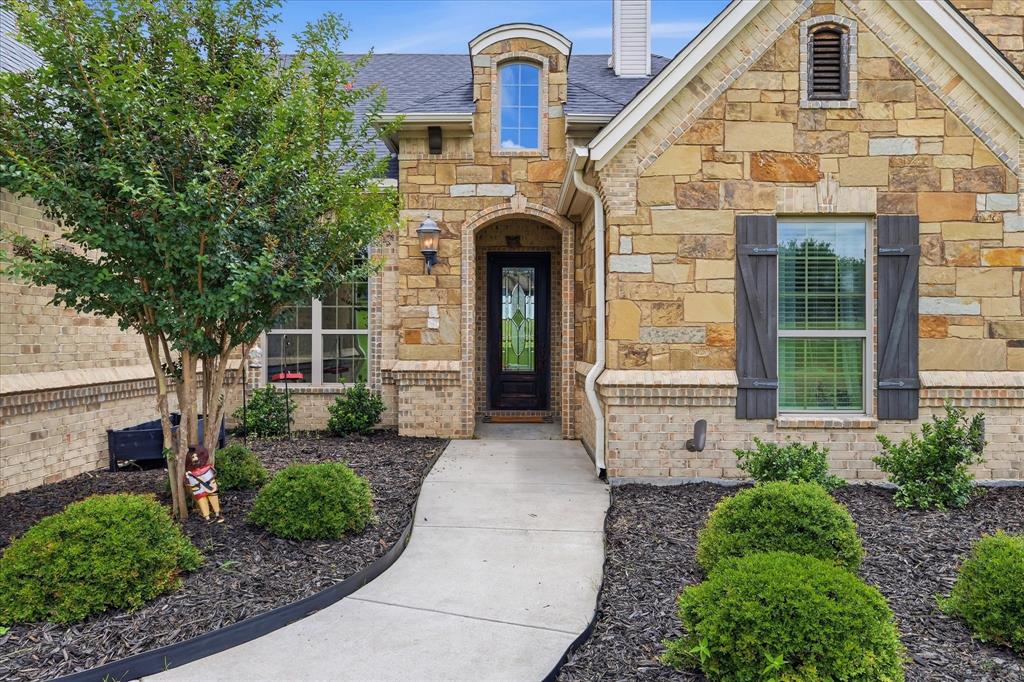 160 Vista Ridge North Decatur, TX 76234 - Photo 3 of 40 a front view of a house with garden