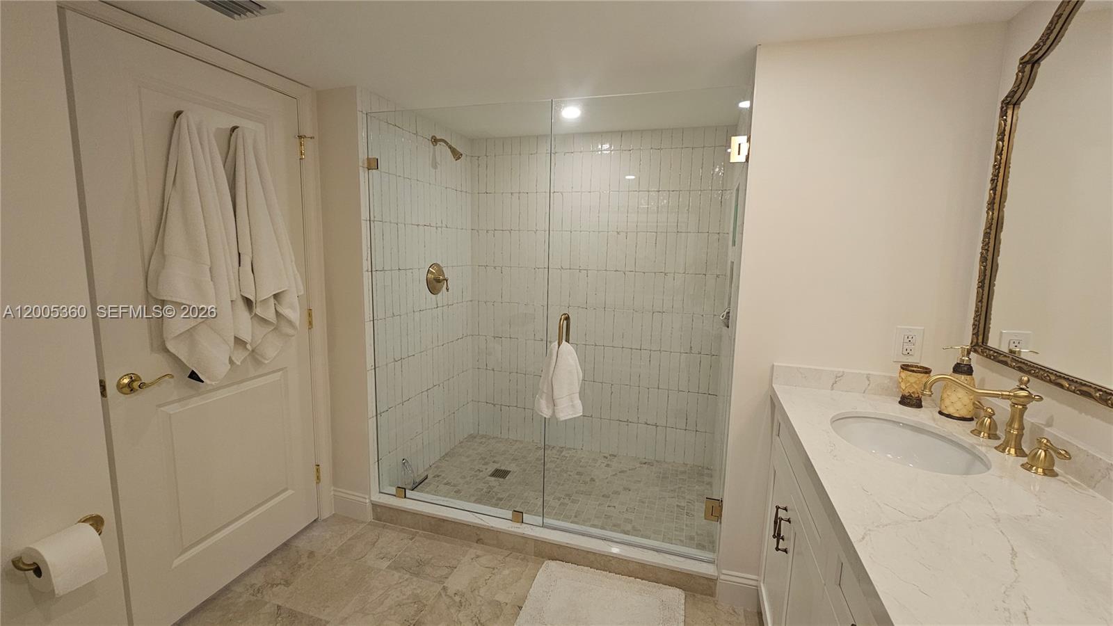 4001 North Ocean Boulevard, Unit 702 Boca Raton, FL 33431 - Photo 30 of 56 a bathroom with a shower and a sink