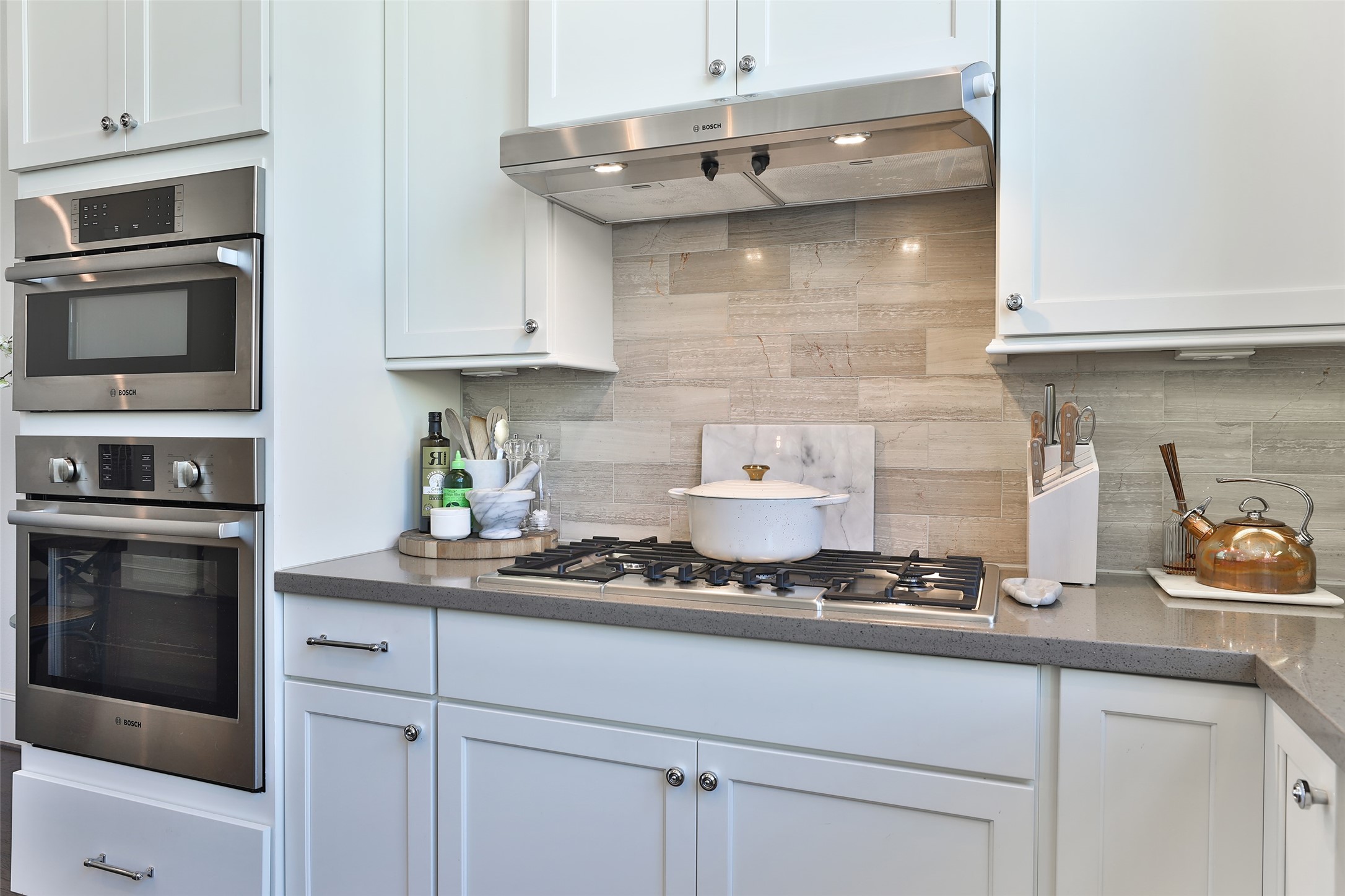 2303 Kolbe Run Lane Houston, TX 77080 - Photo 13 of 35 Enjoy culinary excellence in this sleek kitchen featuring a Bosch gas cooktop, complemented by a Bosch microwave and oven.